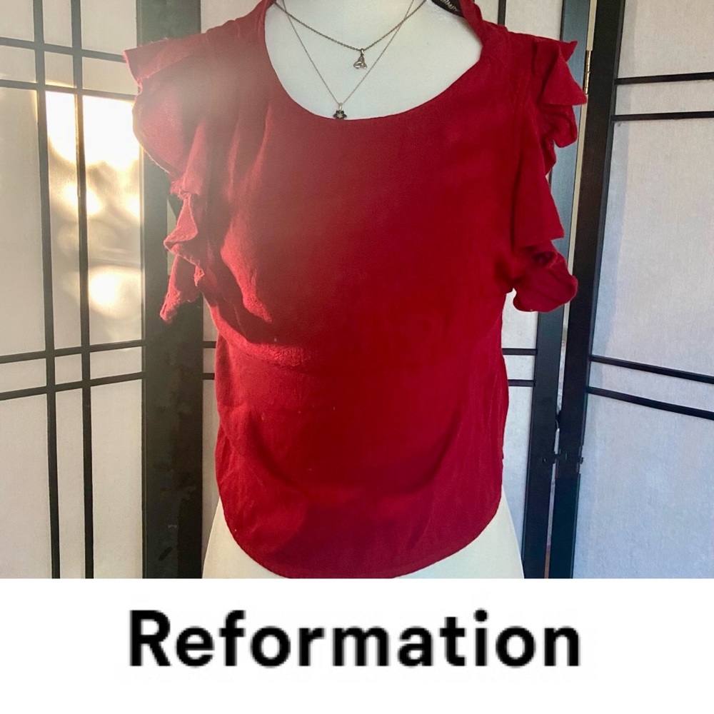 Reformation blouse with a button clasp